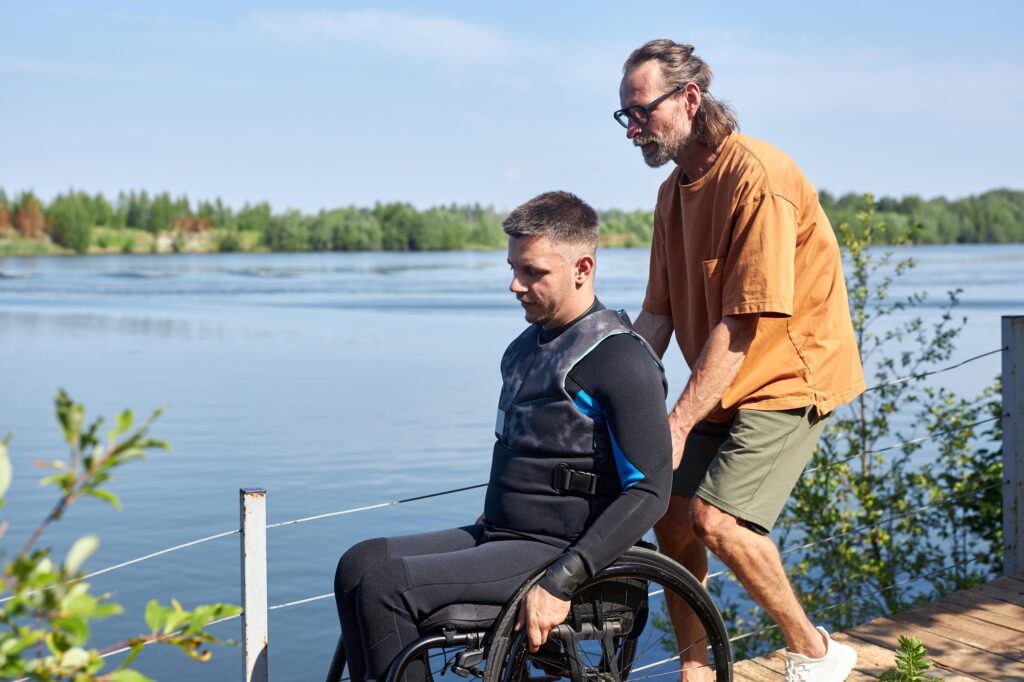 Man with disability ready to scuba dive with instructor assisting